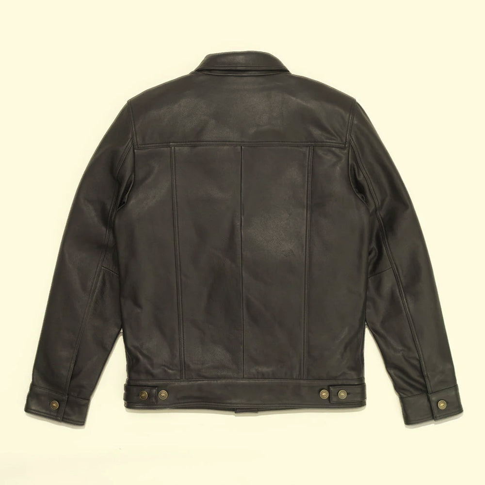 Rear view of the black cowhide Type III trucker jacket showing its shoulder yoke, vertical panels and waist adjusters