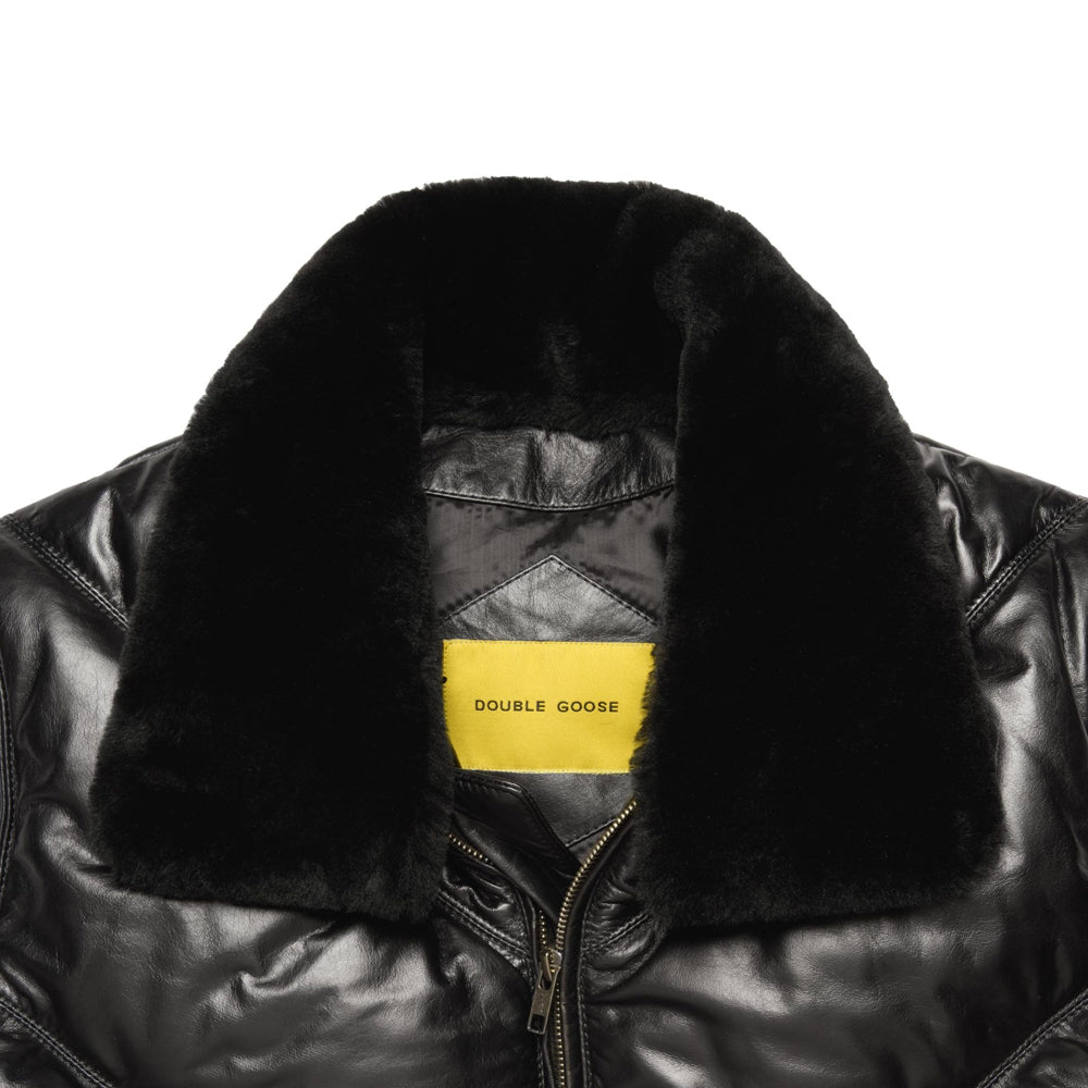 Close-up of dark opossum-fur collar, glossy black calfskin and yellow Double Goose interior neck label