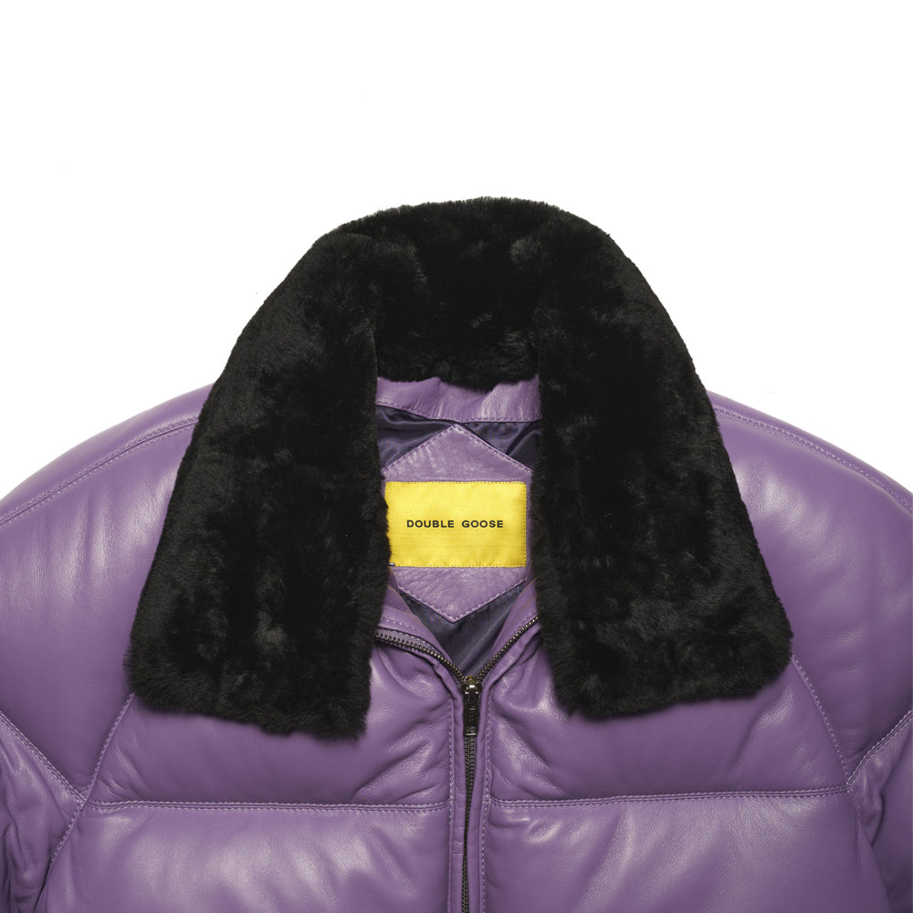Close-up of detachable black sheep-wool collar and yellow Double Goose label on lavender lambskin leather.