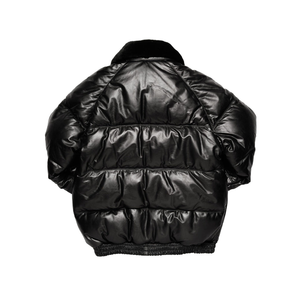 Rear view of black straight-cut leather bomber showing shaped shoulders, broad horizontal baffles and an elasticized waist.