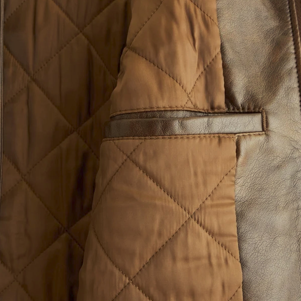 Close-up of brown diamond-quilted jacket lining with a leather-trimmed interior welt pocket