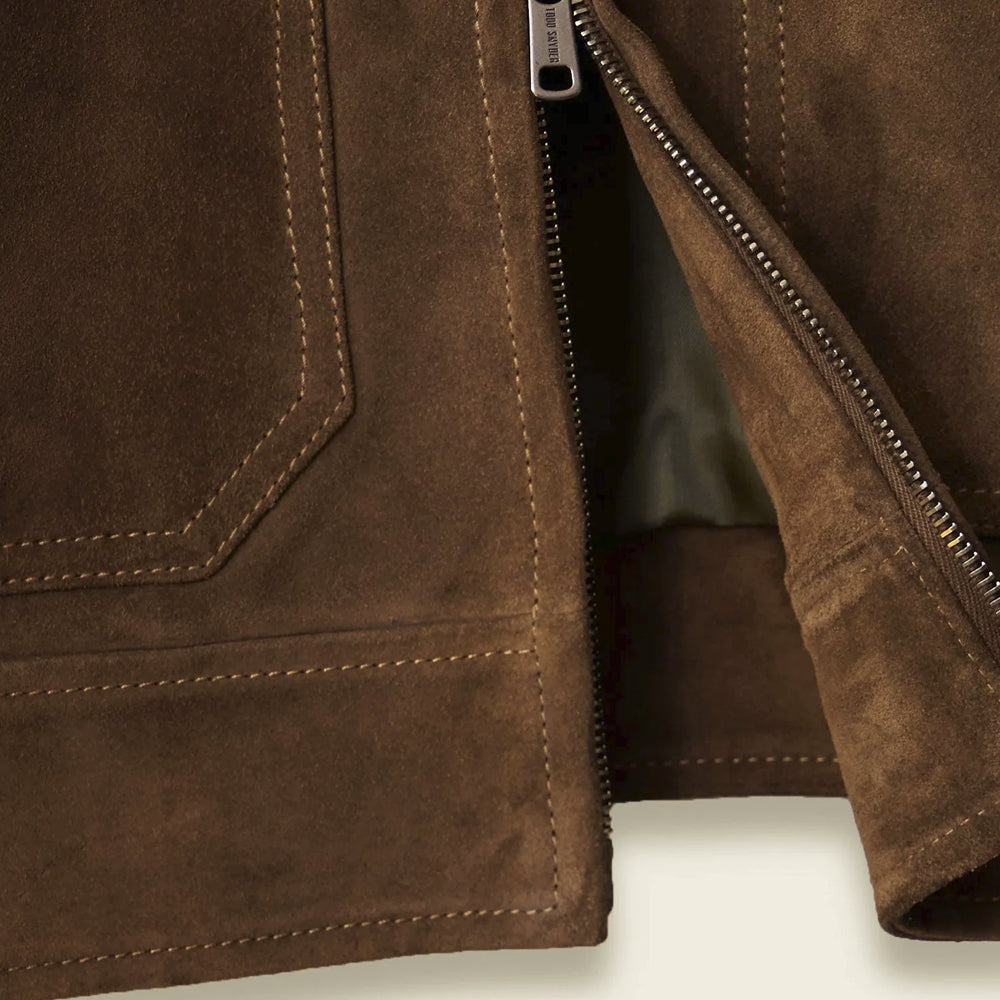 Close-up of chocolate brown suede, tonal reinforced stitching, smooth lining and two-way metal zipper construction