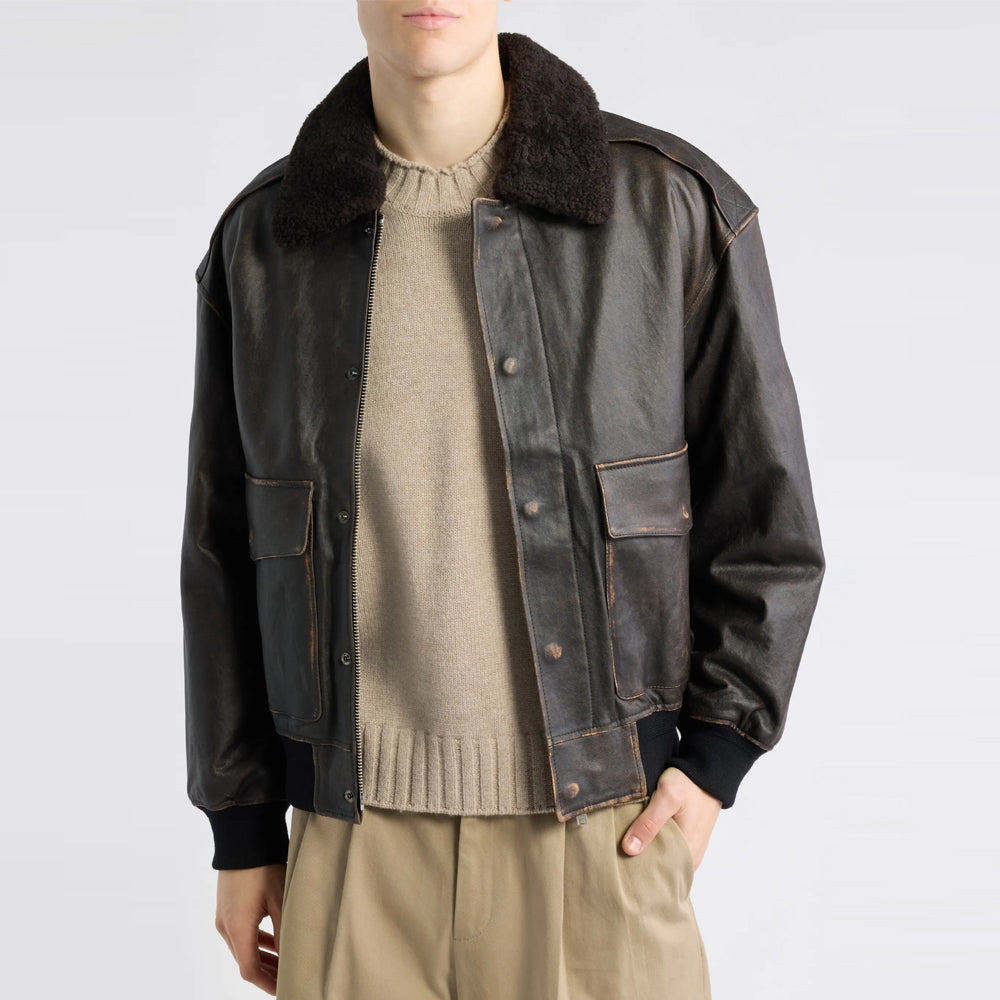 Open brushed-black leather A-2 bomber showing removable shearling trim and covered zipper placket