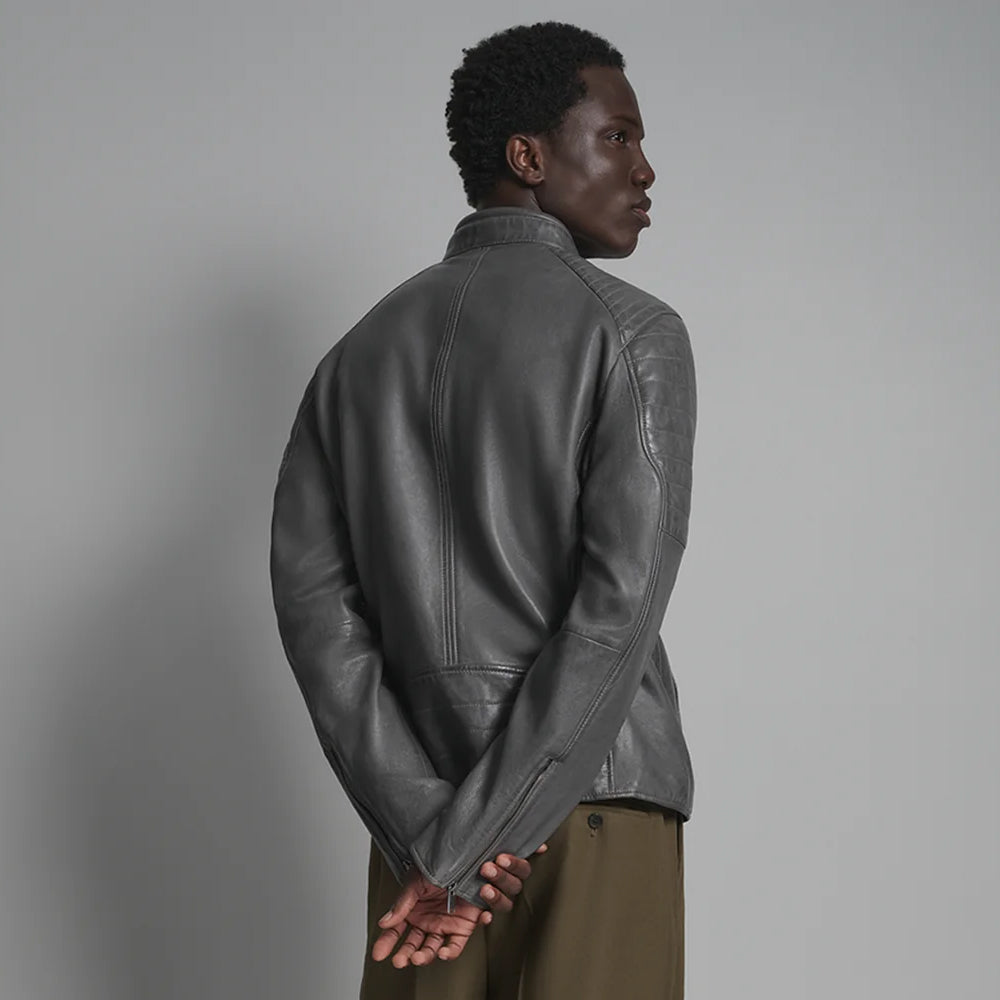 Rear view of charcoal café racer jacket showing center seam, curved shaping and smooth lower-back construction