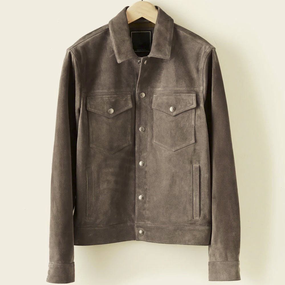 Front view of a charcoal goatskin suede trucker jacket with four pockets, point collar and metal snap closure