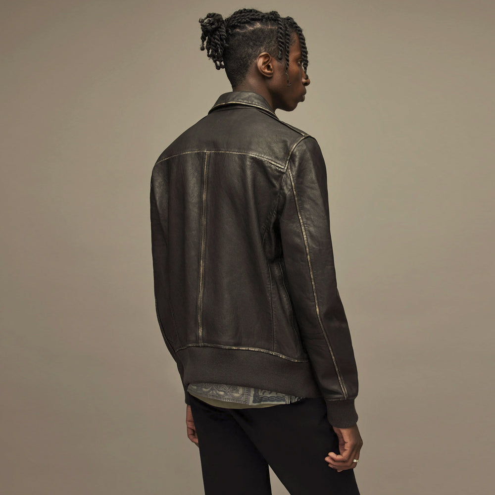 Rear view of distressed black leather bomber with shoulder yoke, center seam and ribbed waistband