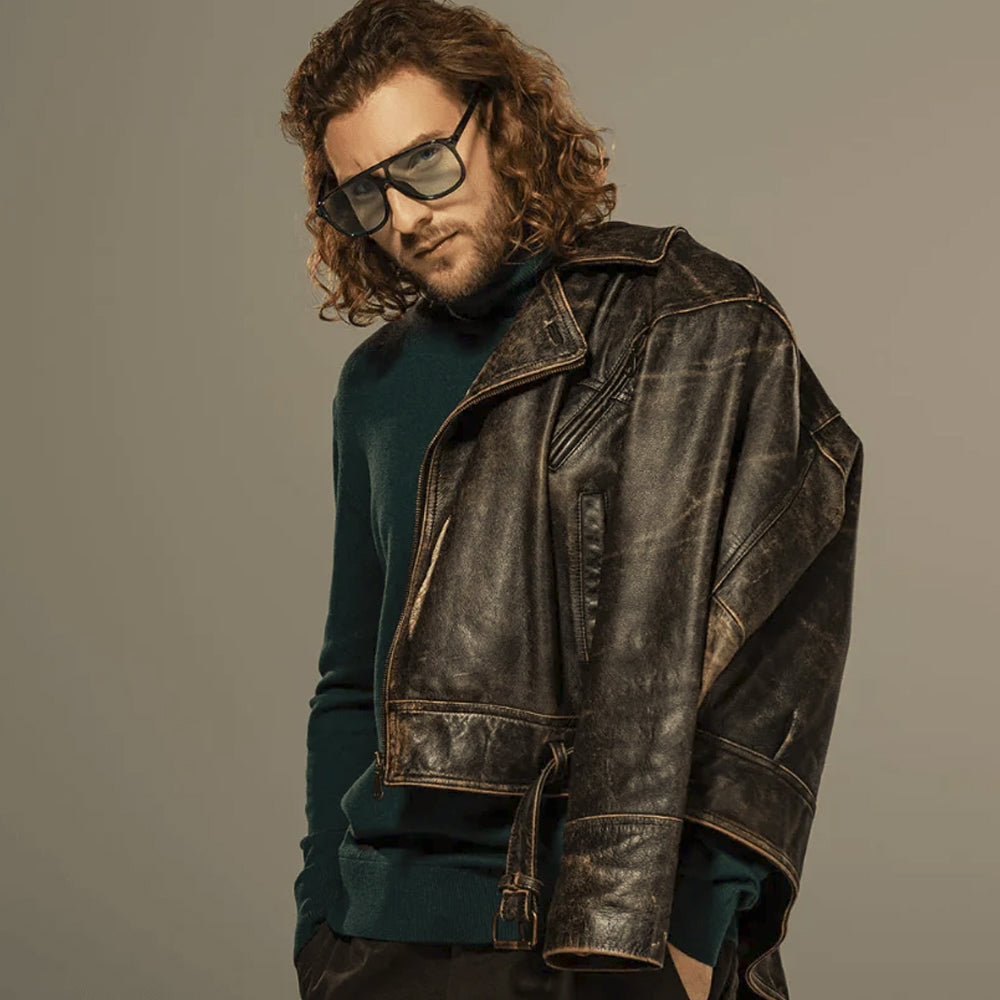 Close view of distressed cowhide motorcycle jacket with raised pocket welt and multi-panel sleeve construction