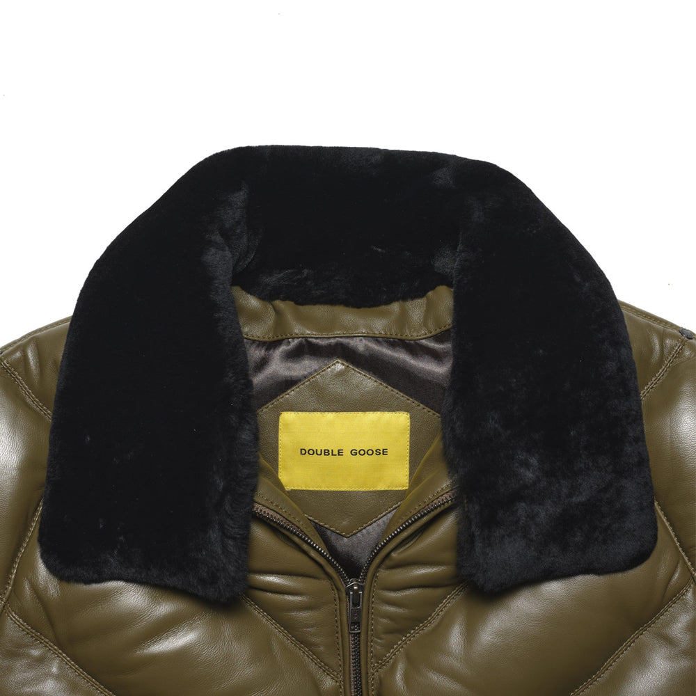 Close-up of detachable black shearling-wool collar and yellow Double Goose neck label on olive lambskin