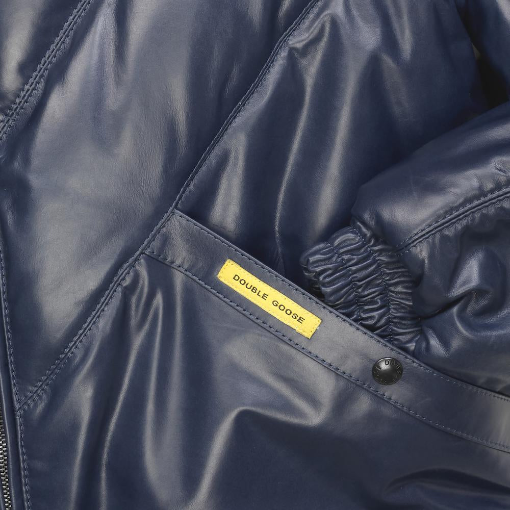 Navy leather welt pocket with branded snap, yellow Double Goose label and gathered elasticated cuff