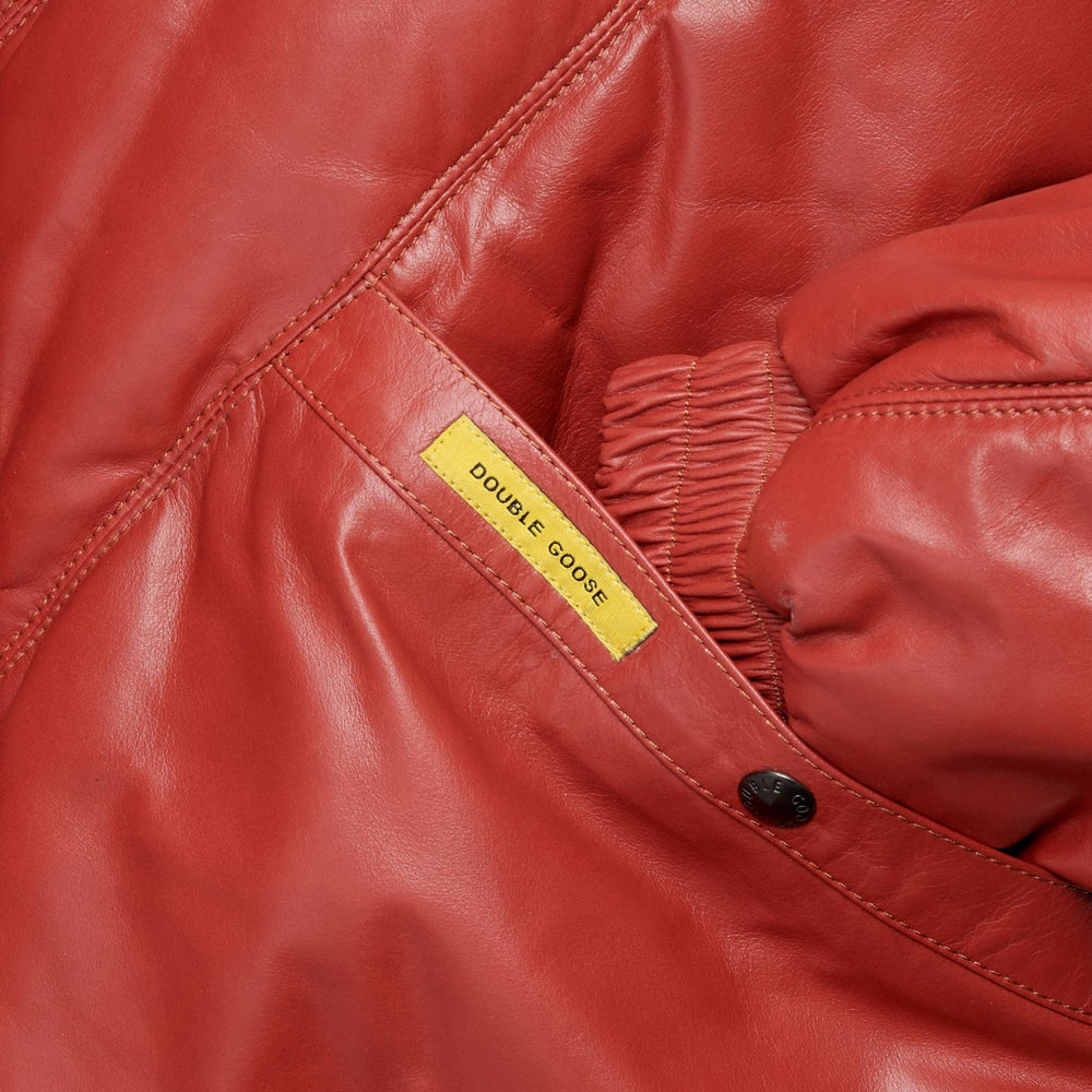 Angled hand-warmer pocket with branded snap, yellow Double Goose tab and gathered red leather cuff