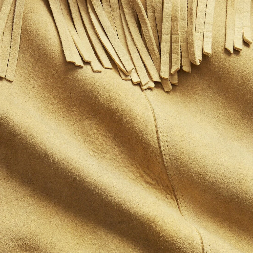 Detailed view of genuine goatskin suede nap, tonal stitching and layered rear fringe in sand beige