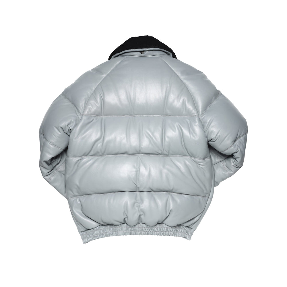 Back view of the light grey lambskin bomber showing broad horizontal down baffles and an elasticated leather waist