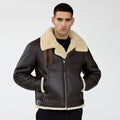 Front view of a man wearing a dark brown B-3 shearling aviator jacket with cream trim.
