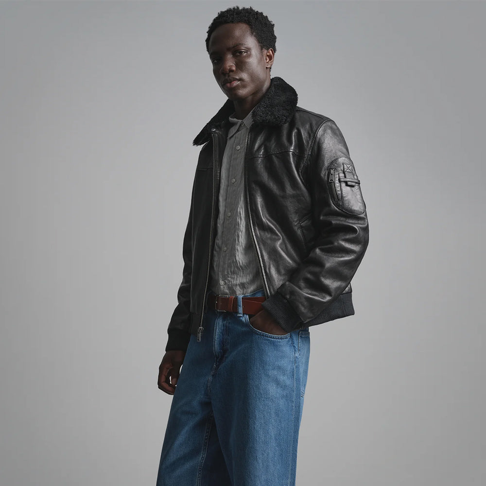 Men’s waist-length black aviator jacket with removable fleece collar, center zipper and polished leather grain