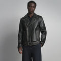 Front view of men’s black belted leather biker jacket with asymmetrical zipper, snap lapels and curved zip pockets