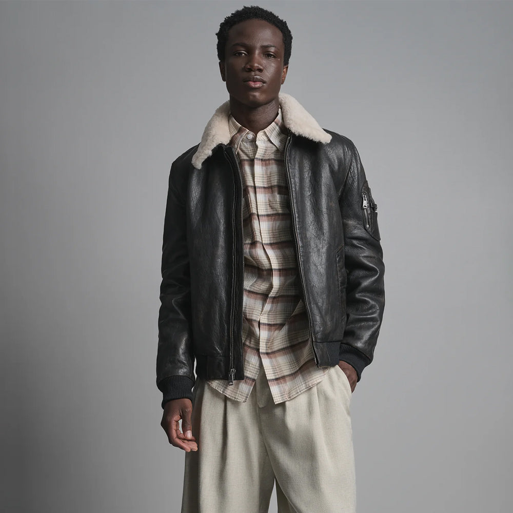 Men’s black leather flight jacket front with removable ivory fleece collar, center zipper and ribbed cuffs