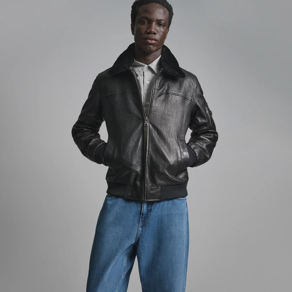 Men’s black leather bomber front with removable black lamb-shearling collar, welt pockets and rib-knit waistband