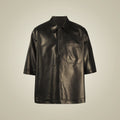Front view of men’s black sheepskin leather popover shirt with pointed collar, hidden half placket and chest pocket