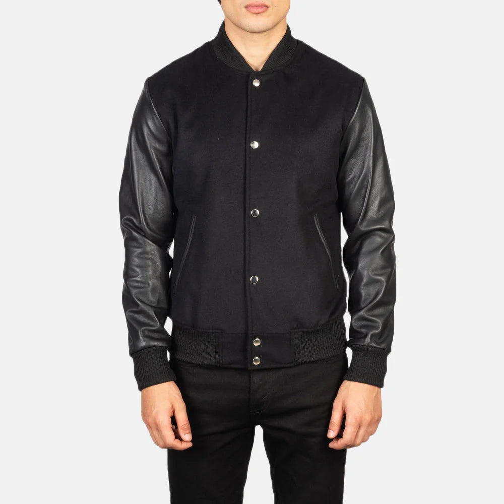 Front view of men’s black wool varsity jacket with genuine leather sleeves and silver snap closure