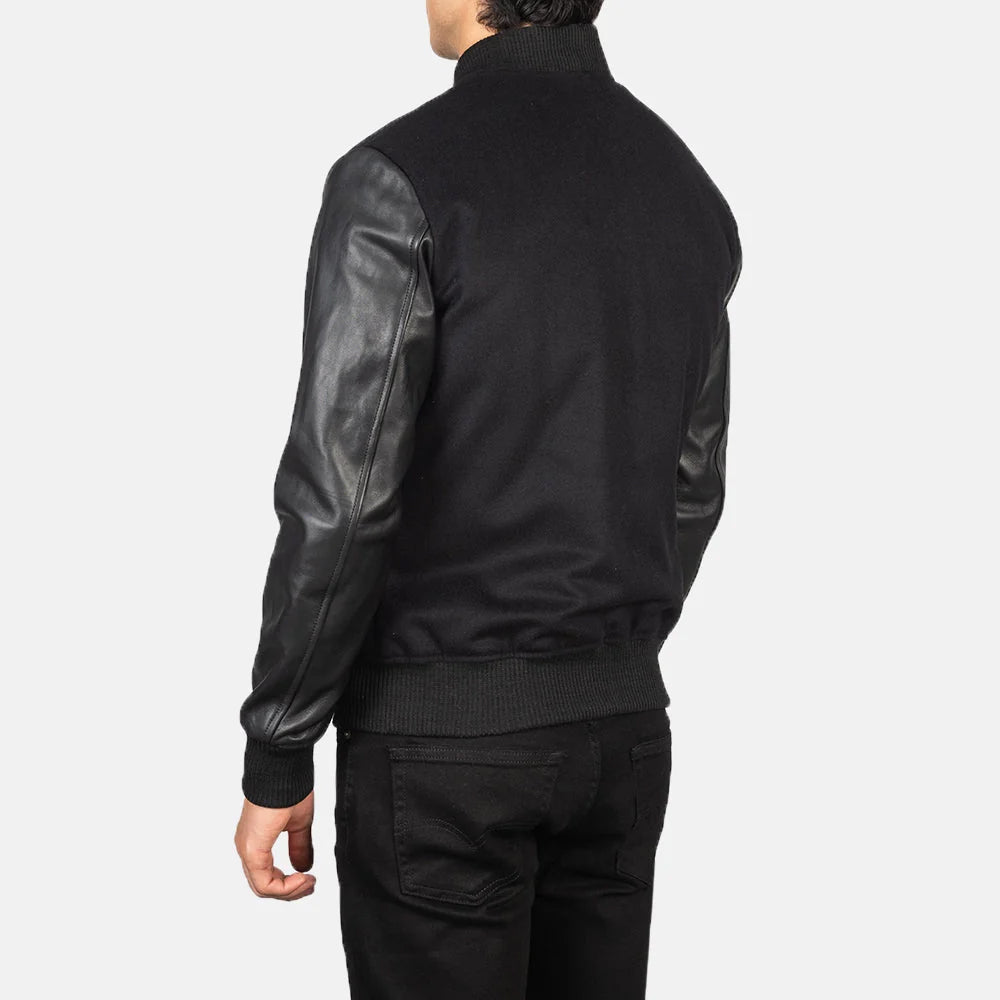 Back view of men’s black wool letterman jacket with genuine leather sleeves and plain patchless panel