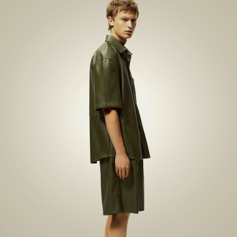 Side view of male model wearing a boxy olive leather overshirt with wide half sleeves and dropped shoulders