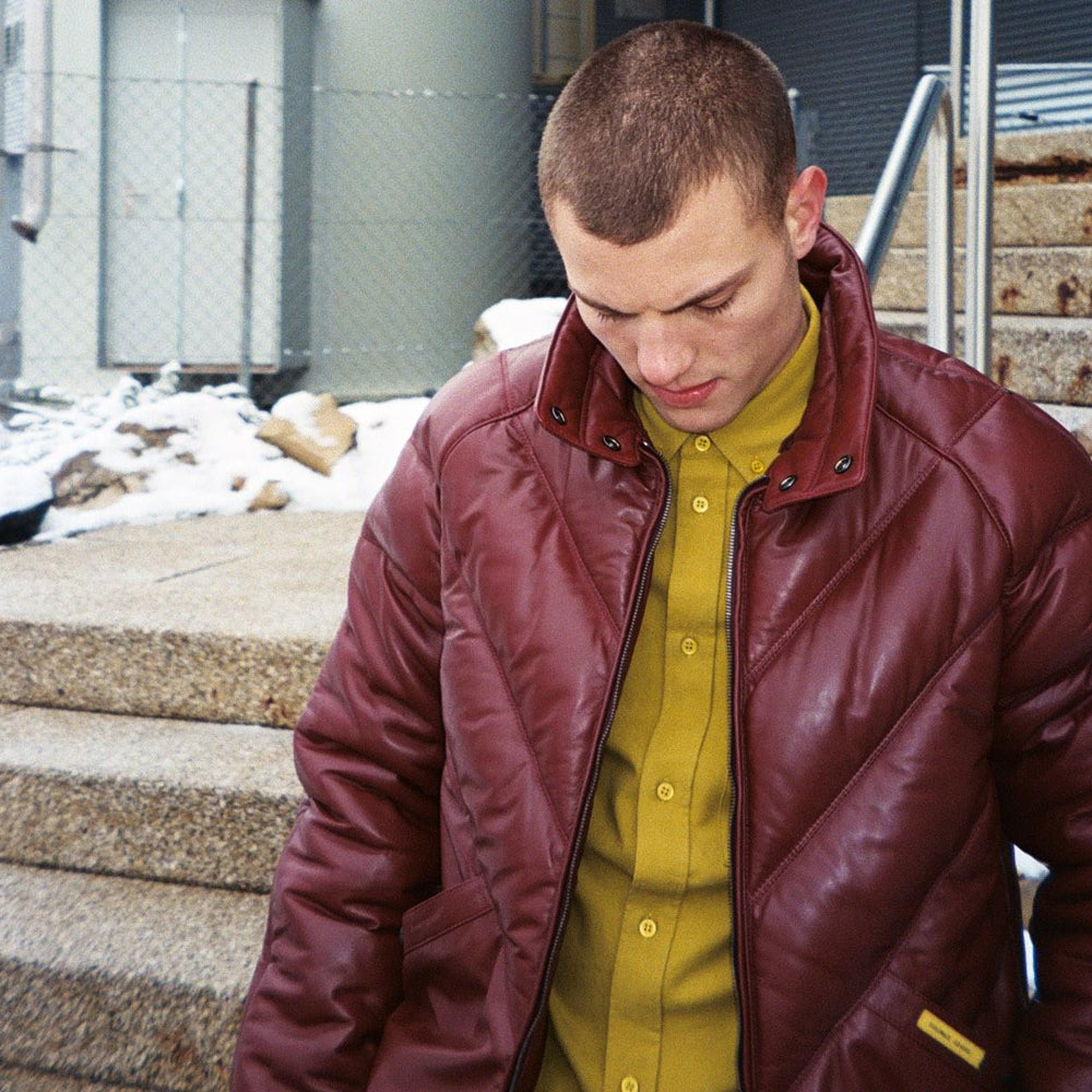 Man wearing a burgundy Double Goose V-Bomber without its fur trim over a mustard button-front shirt
