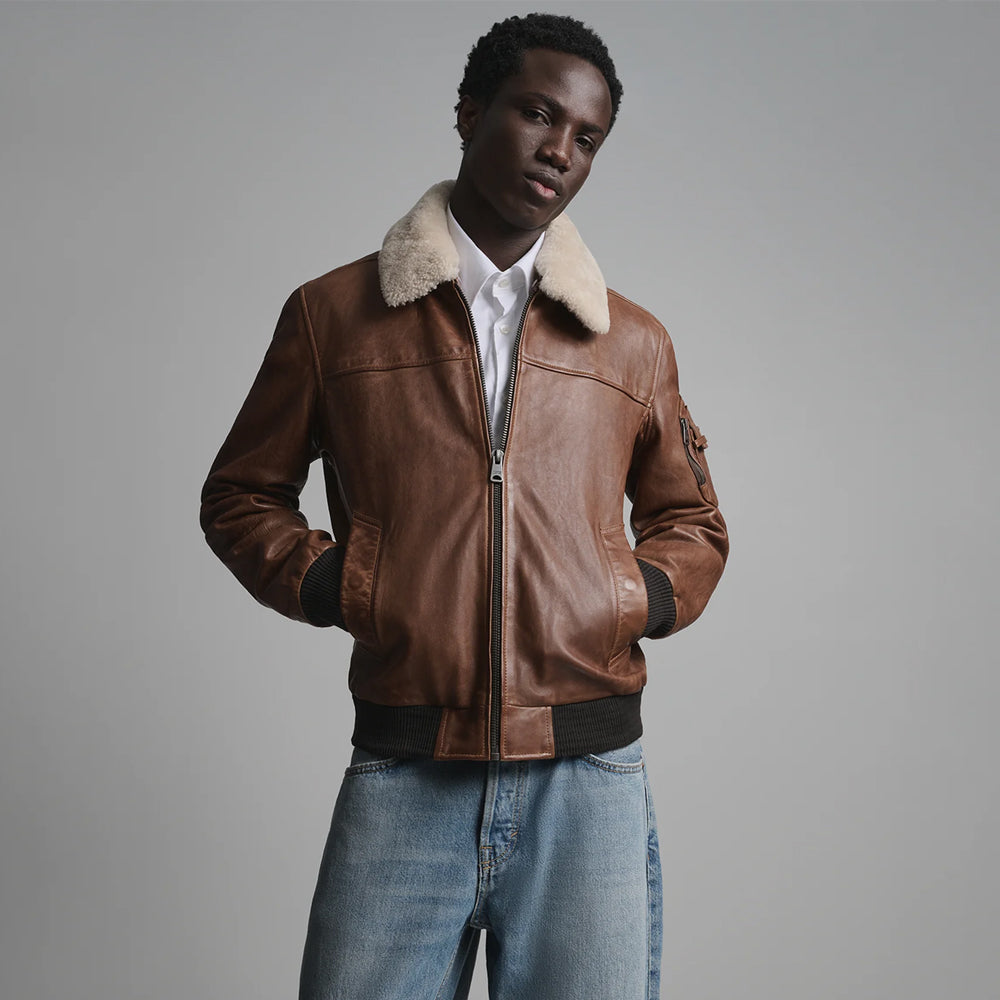 Men’s cognac leather aviator jacket front with removable cream lamb-shearling collar and rib-knit hem