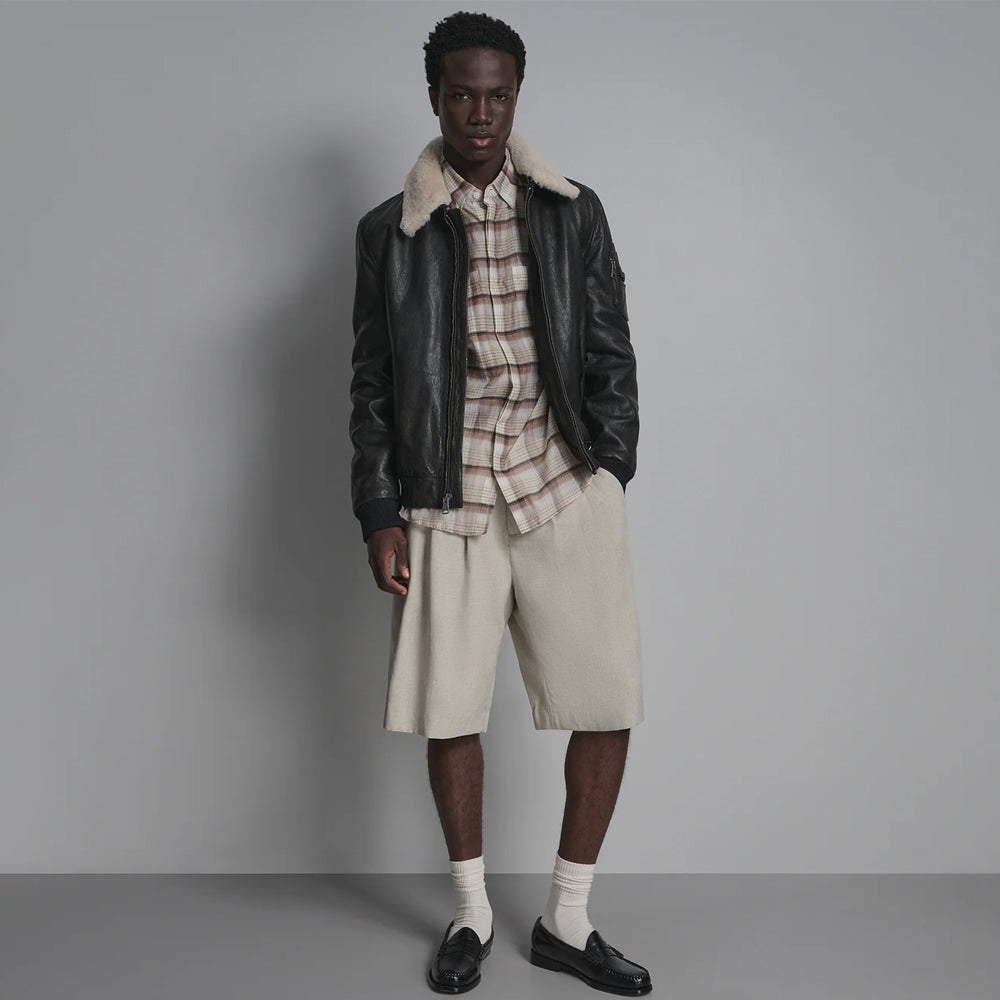 Full-length styling view of men’s contrast-collar aviator jacket worn with plaid shirt and neutral shorts