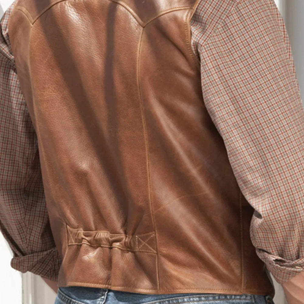 Close-up of gathered rear waist cinch and curved Western yoke on a tan leather cowboy vest