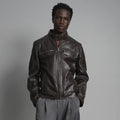 Front view of men’s espresso leather café racer jacket with snap-tab collar, four zip pockets and quilted shoulders