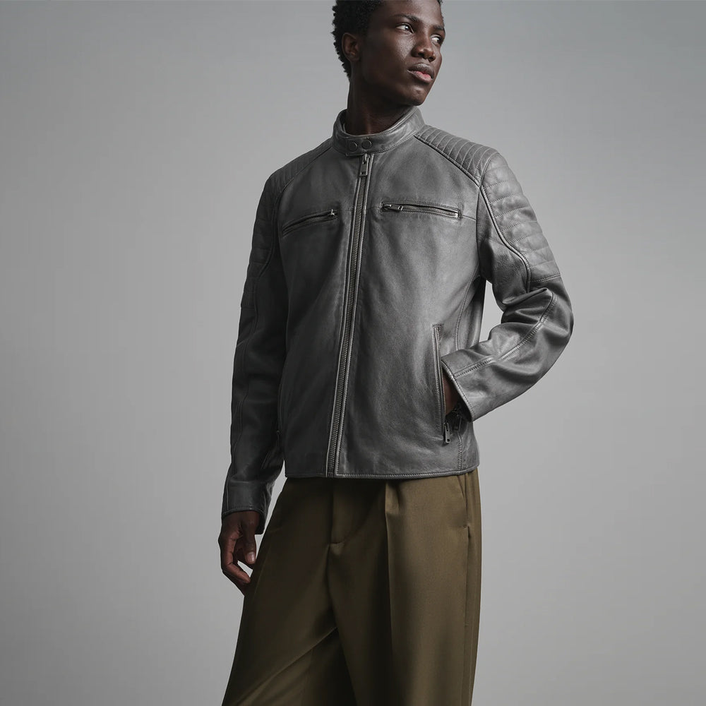 Three-quarter view of men’s gray leather motorcycle jacket with four zip pockets and channel-stitched sleeves