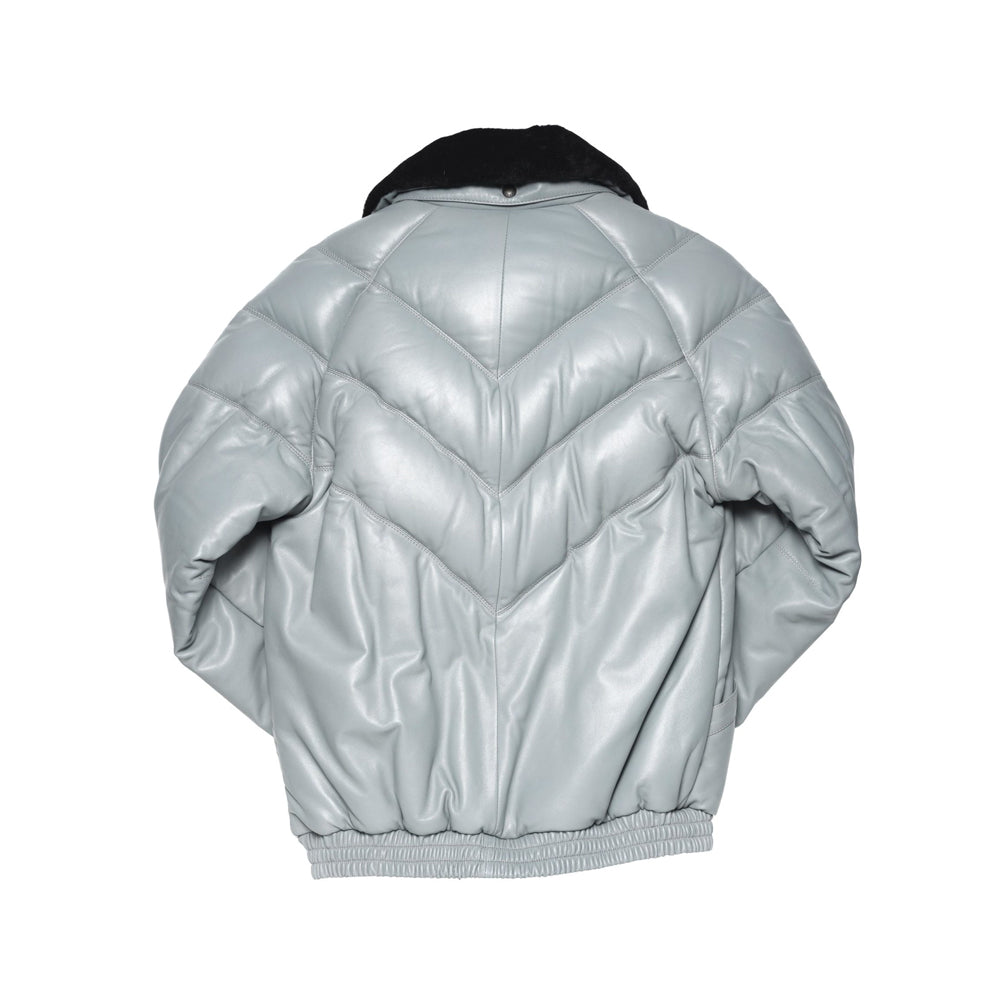 Back view of a light grey leather down bomber showing stacked V channels, center seam and gathered waistband