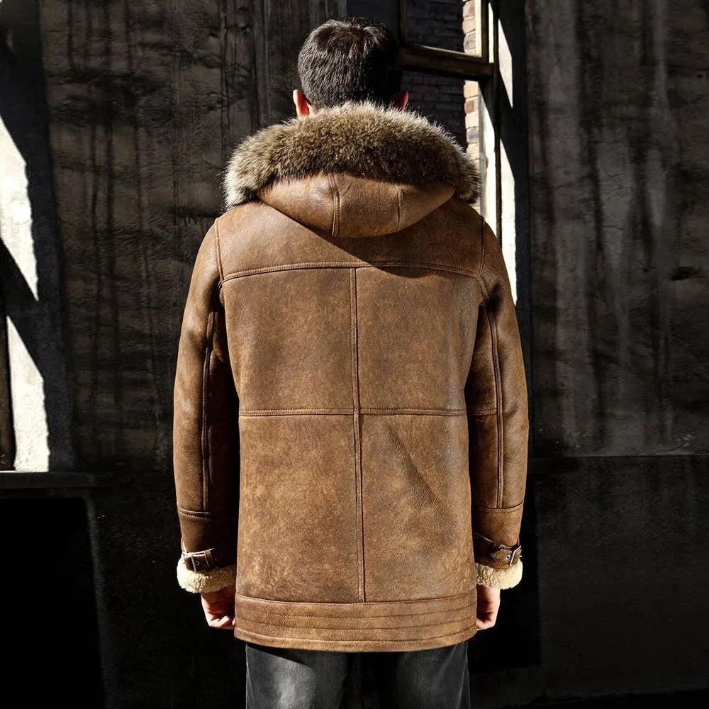 Back view of a men’s tan longline shearling coat with a fox fur-trimmed hood.