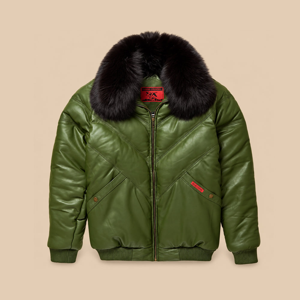 Front view of men’s olive lambskin leather V-Bomber with tonal chevron panels and a removable black fox fur collar.