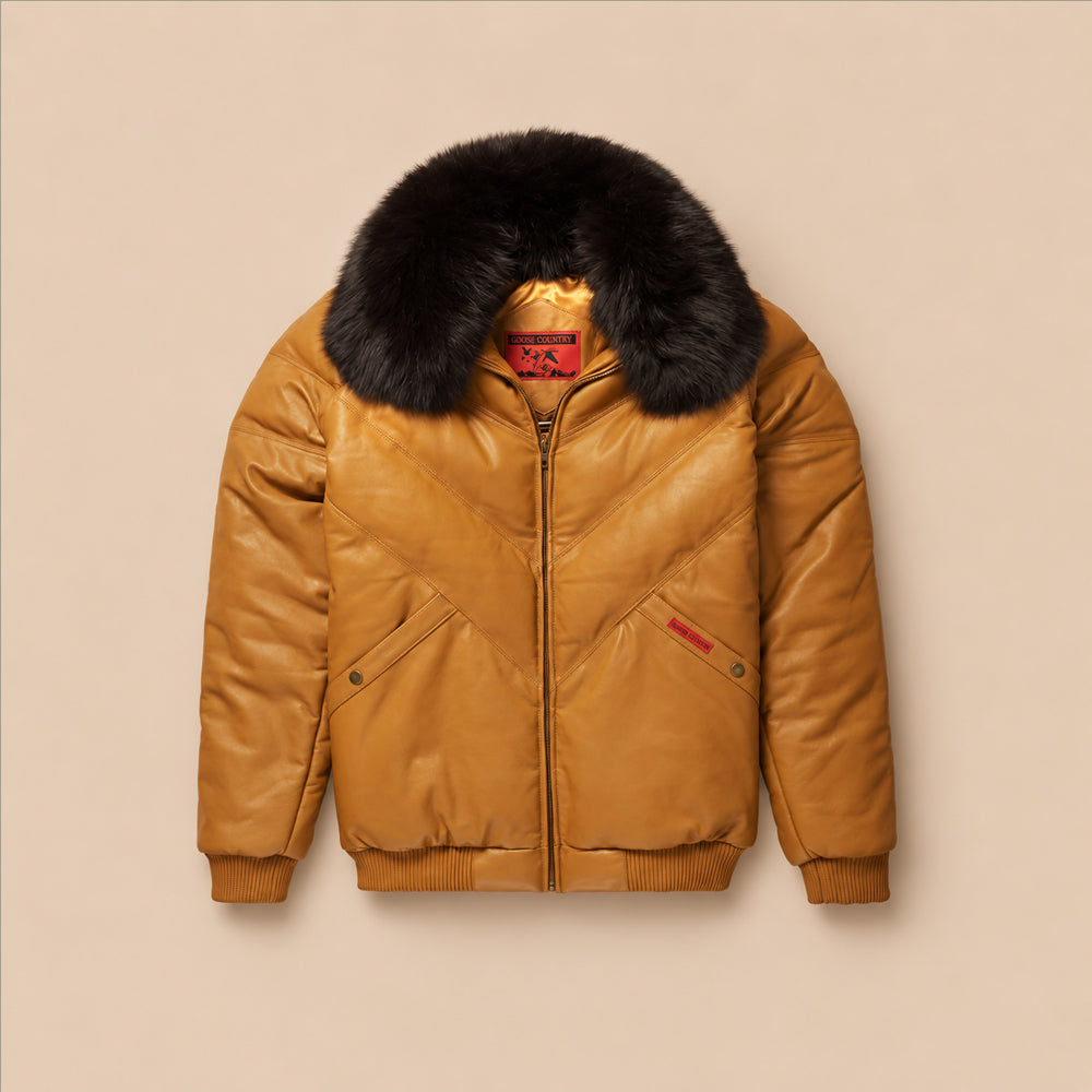 Front view of men's Original Goose Country cognac leather V-bomber jacket with tonal chevron panels and detachable black fox-fur collar.