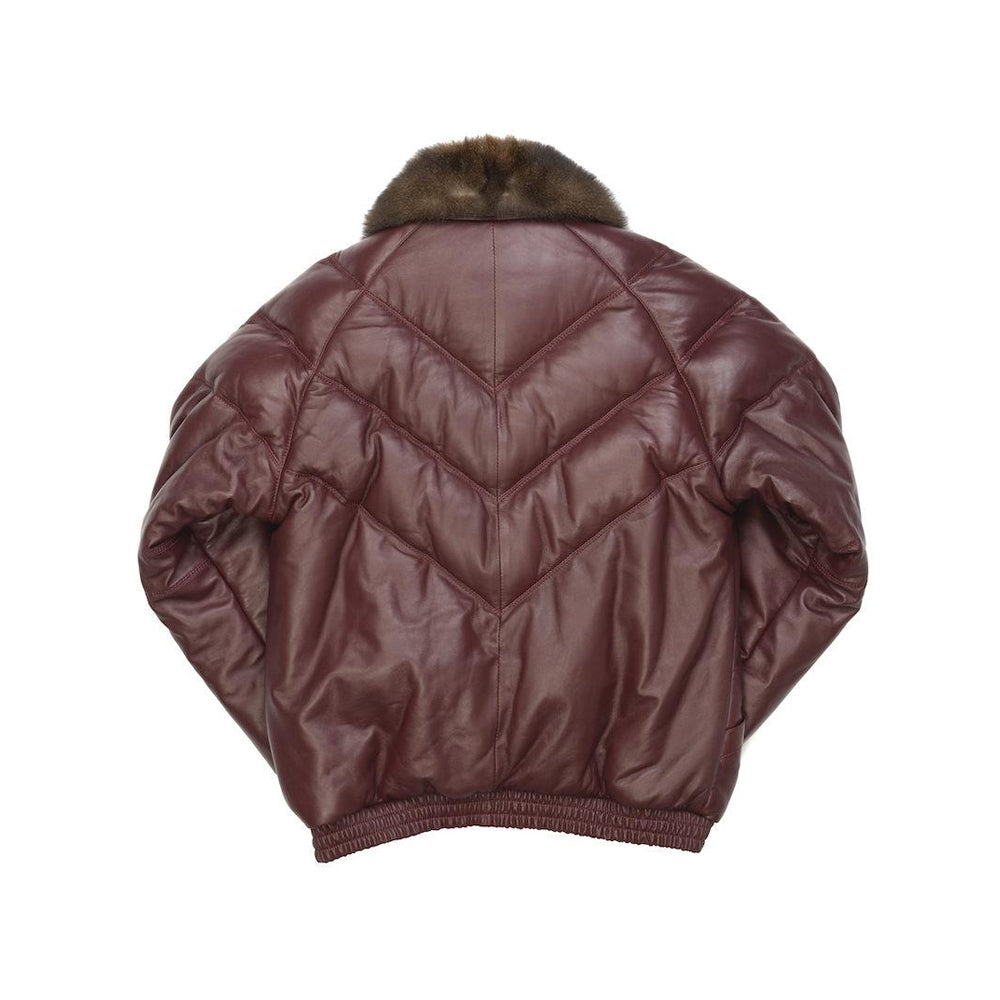 Back view of men’s oxblood leather down bomber showing layered V channels, center seam and gathered waistband