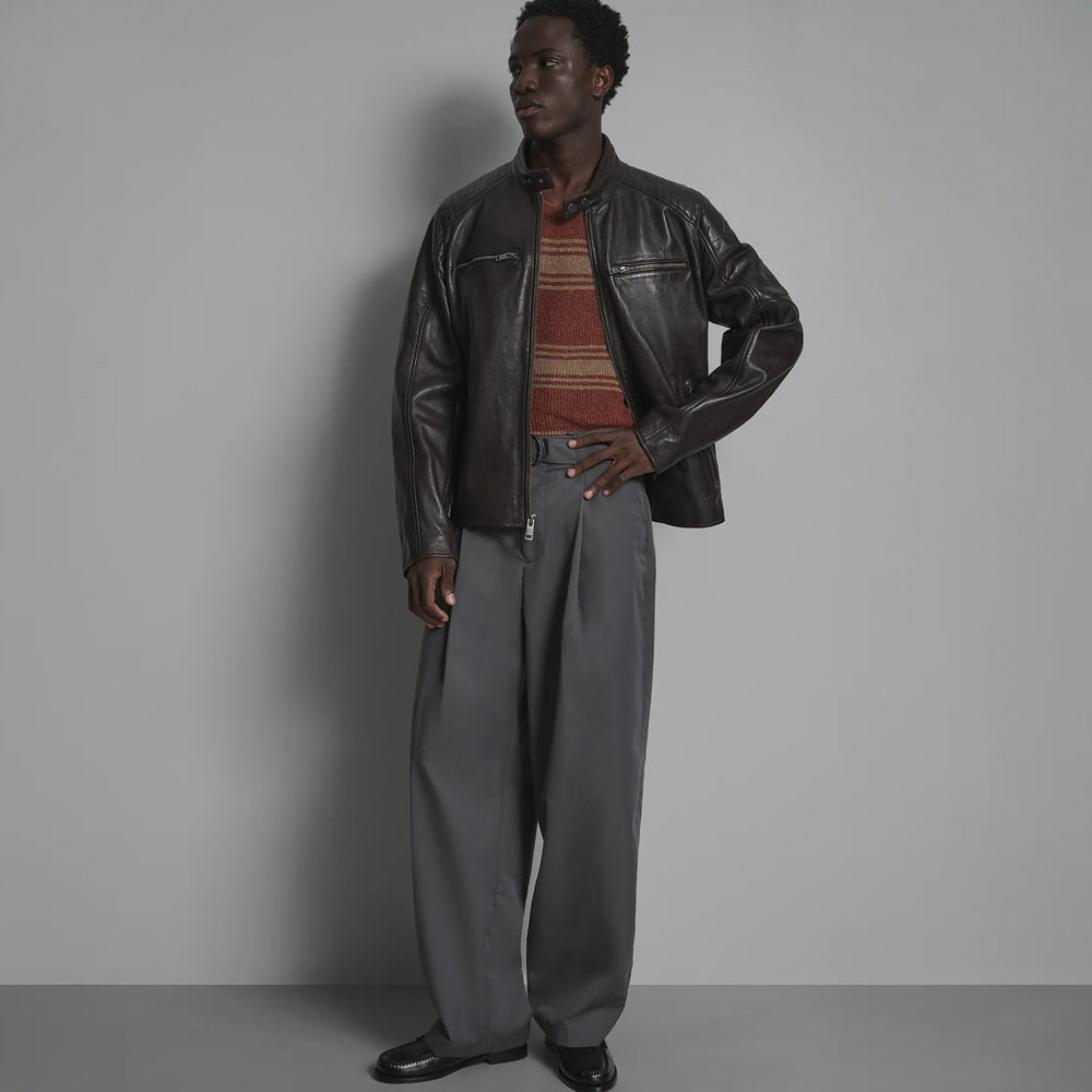 Full-length view of men’s stand-collar leather jacket worn open with straight zipper and horizontal chest pockets