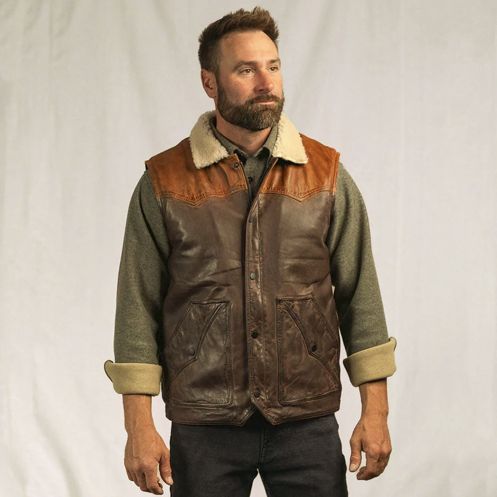 Men’s Western shearling waistcoat layered over a gray sweater with dark denim for cold-weather ranch styling
