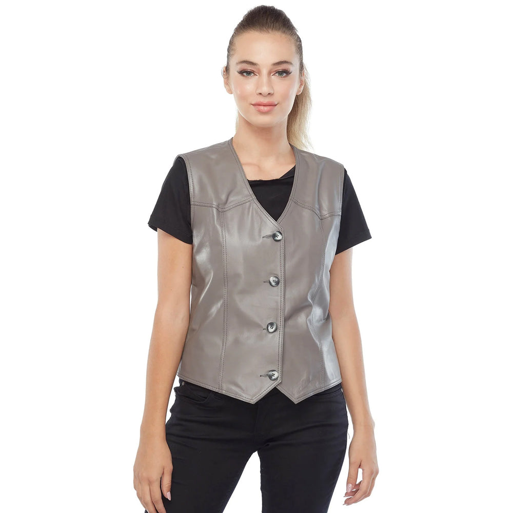 Studio shot of a model styling a cropped slate grey leather vest with a pointed hem.