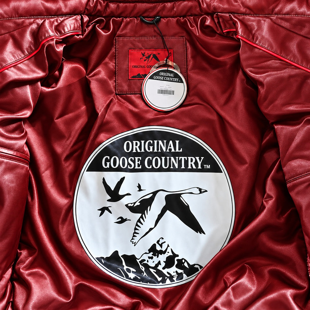 Burgundy satin interior of an Original Goose Country jacket with circular goose artwork, red piping, woven label and hangtag.