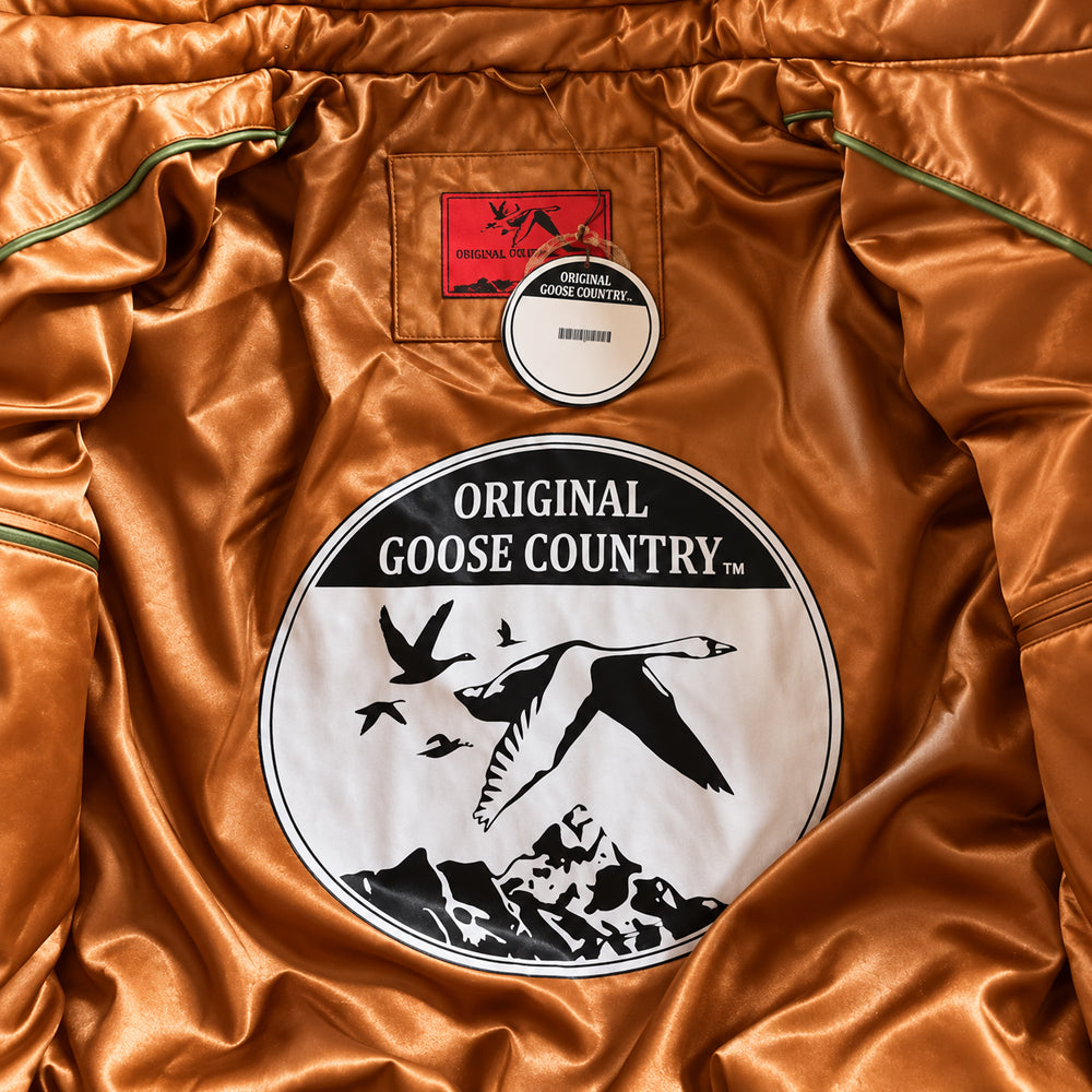 Interior of Original Goose Country caramel and olive leather V-bomber jacket with tonal viscose lining and logo patch.