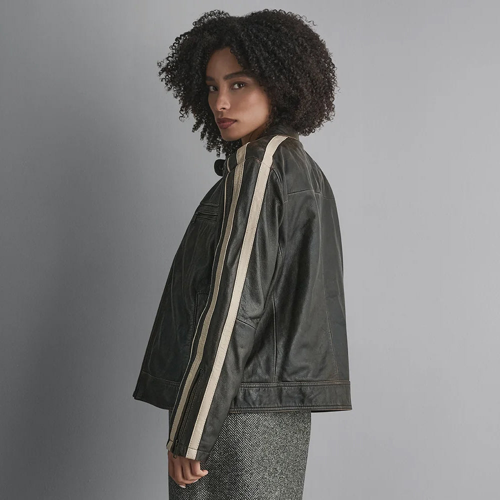 Side view of oversized lambskin motorsport jacket showing ivory sleeve bands, zip cuff and straight hip-length hem