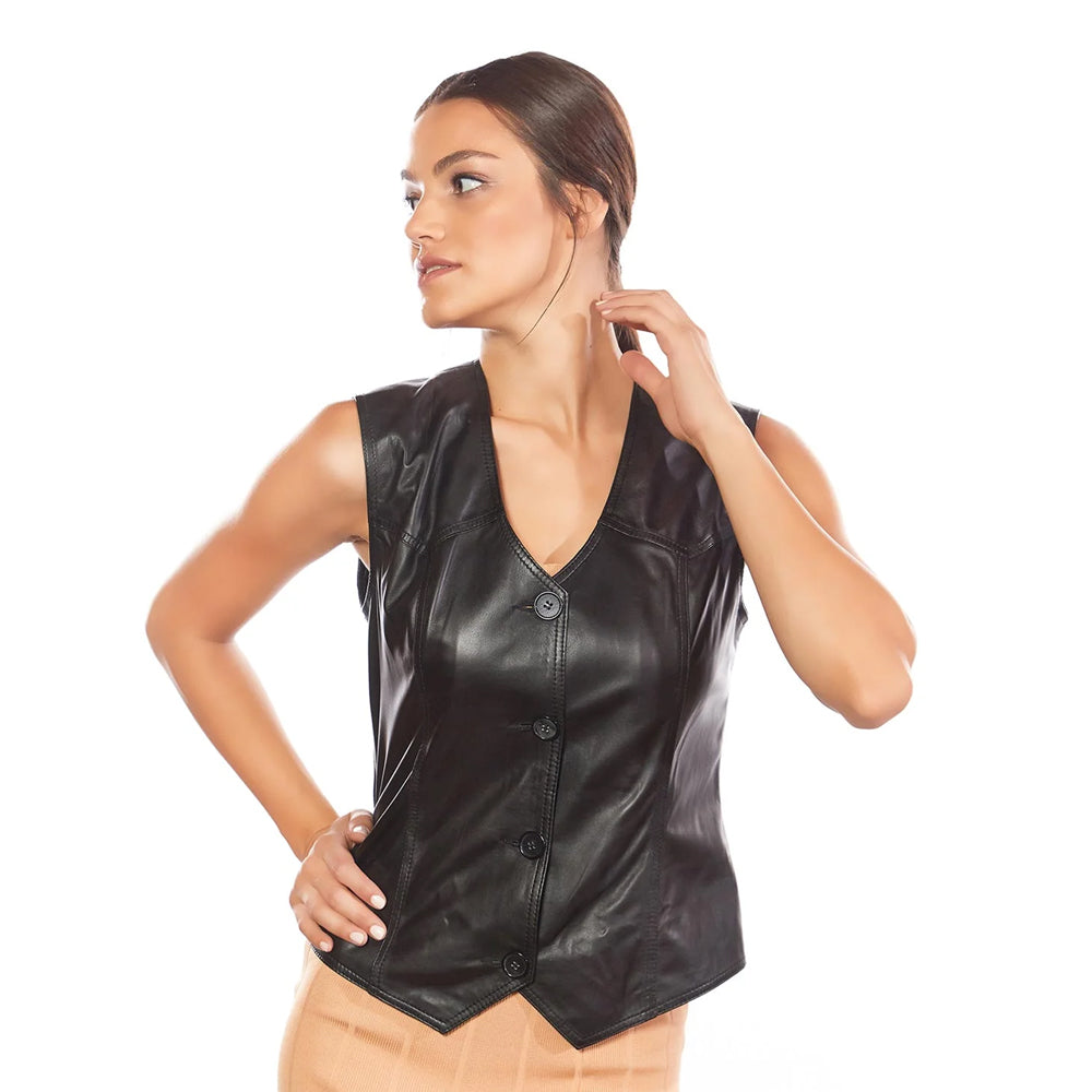Side profile of a woman in a tailored black leather top featuring a classic pointed handkerchief hemline.