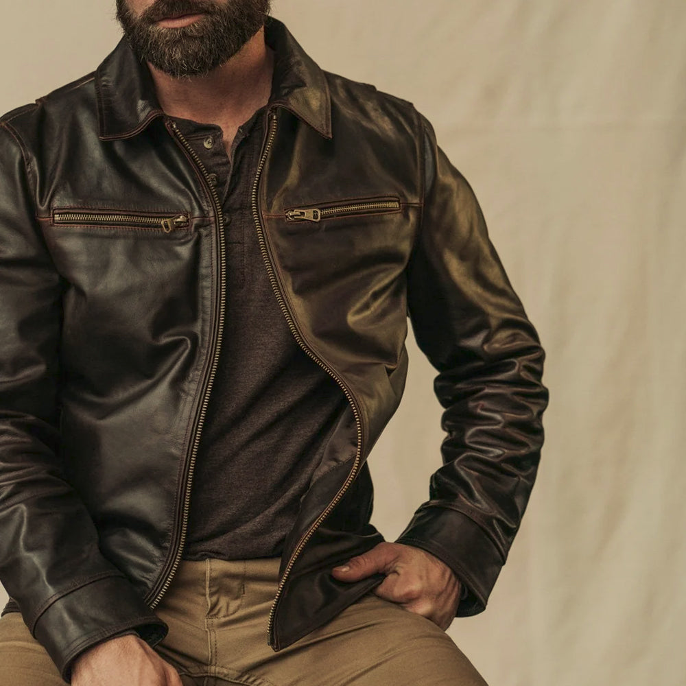 Man wearing a vintage brown full-grain cowhide jacket with an open YKK zipper and point collar
