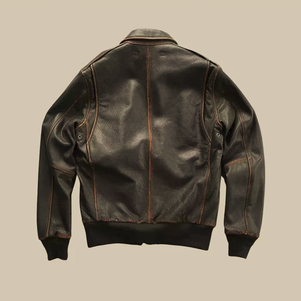 Rear view of vintage brown leather bomber showing shoulder yoke, center seam and rib-knit waistband