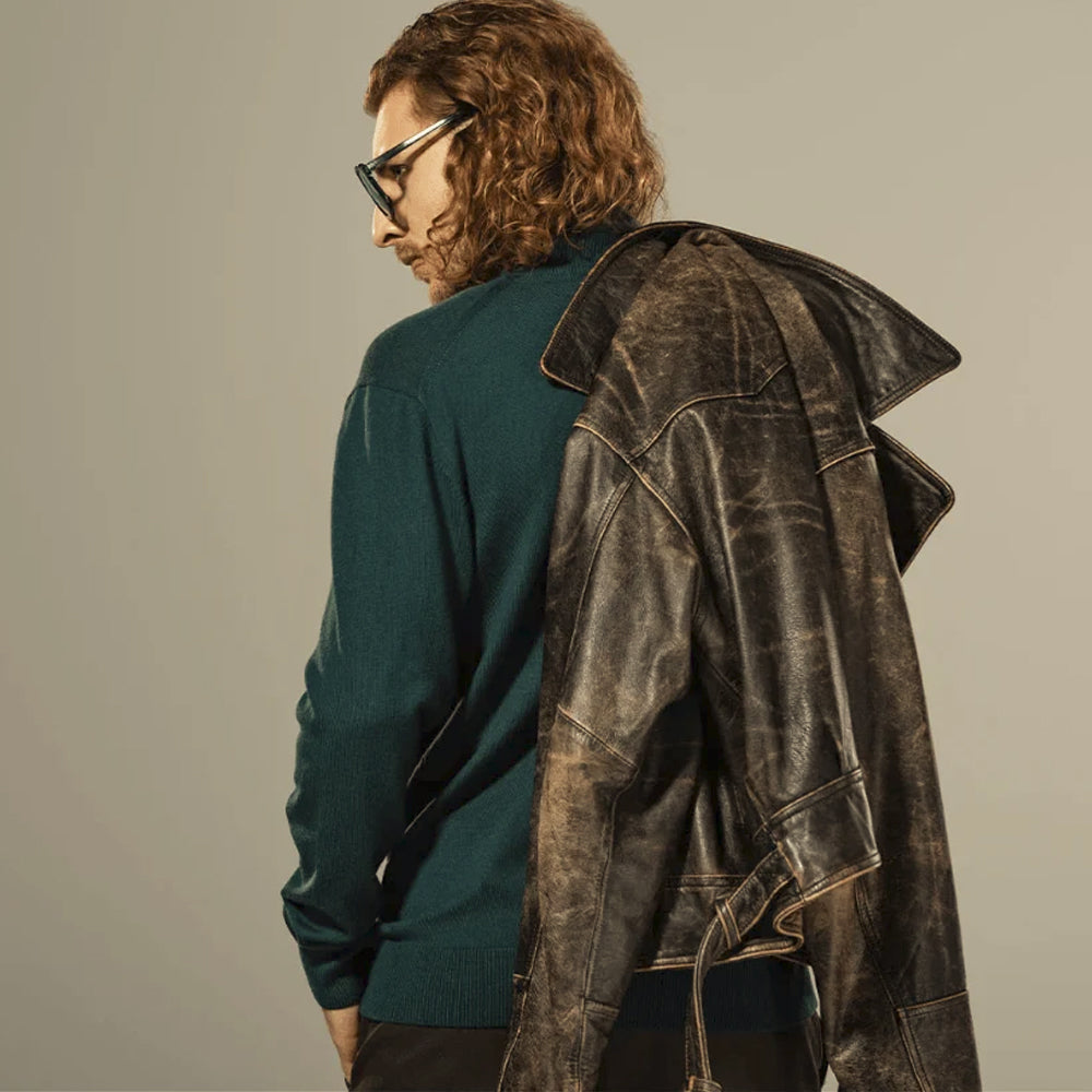 Over-shoulder view showing shaped rear panels and distressed finish on a vintage cowhide cross-zip jacket