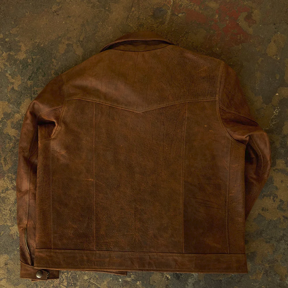 Back view of the waxed brown leather work jacket showing its curved shoulder yoke, center seam and straight hem band