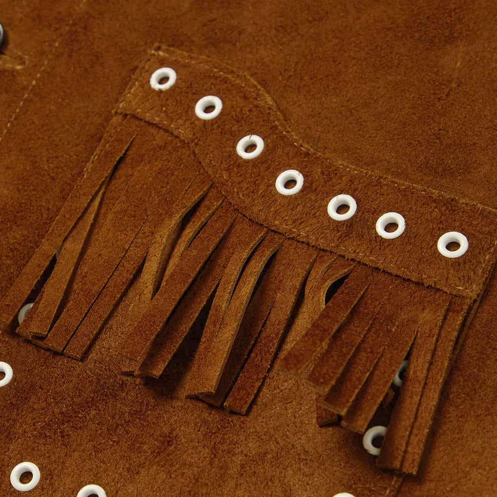 Close-up of white metal eyelets and layered fringe on warm-brown genuine goatskin suede