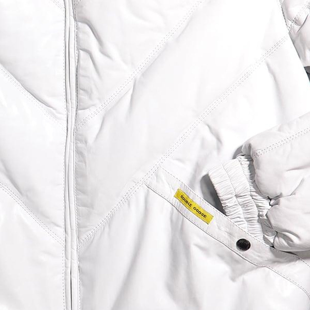 Close-up of white leather welt pocket with yellow Double Goose tab, dark branded snap and gathered cuff