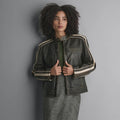 Women’s black and cream leather racer jacket front view with snap-tab collar, shoulder stripes and horizontal chest zip pocket